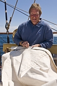 John sail-making on the quarterdeck