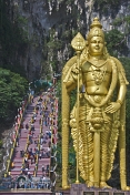 Pilgrims climb past the 43m high statue of Lord Murugan