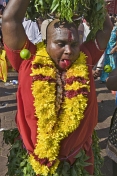 A skewer pierces the cheeks and tounge of this Thaipusam pilgrim