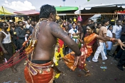 Two Thaipusam pilgrims dance in the street near the Batu Caves