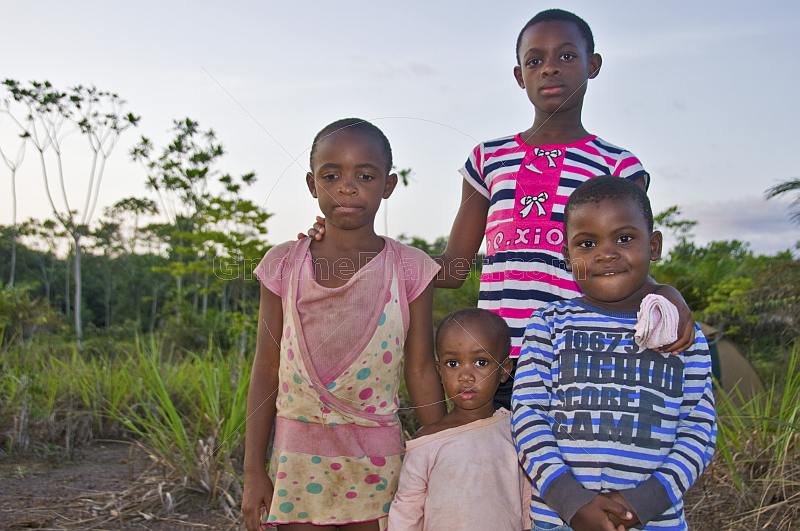 A family group of Gabonese children in colorful clothes are unused to having their photograph taken.