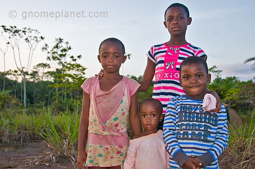 A family group of Gabonese children in colorful clothes are unused to having their photograph taken.