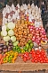 Image of Assorted vegetables peanut sauce and dried goods for sale on a market stall.