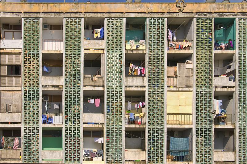Balconied apartment building with laundry drying in the sun.