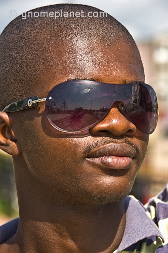 Man with shaved head and sunglasses.
