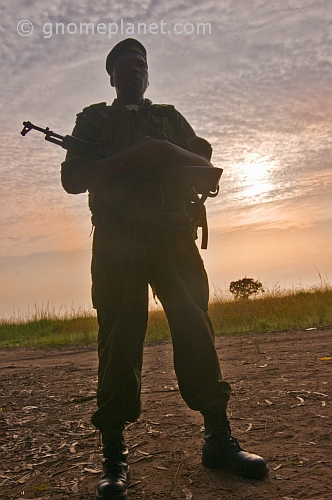 An Angolan soldier with assault rifle silhouetted at dawn.
