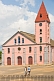 Image of Two boys walk to see the pink-painted Church of the Catholic Mission.