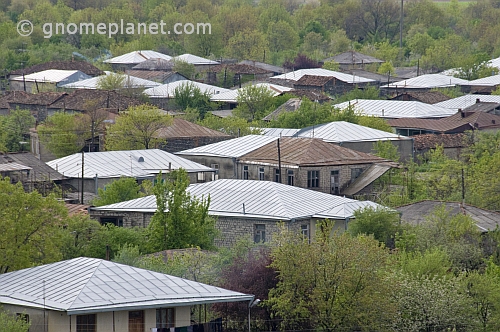 Pattern of silver rooftops peak through the trees in the village of Kvareli.