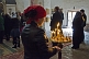 A woman lights a candle during mass at the Ananuri Monastery.