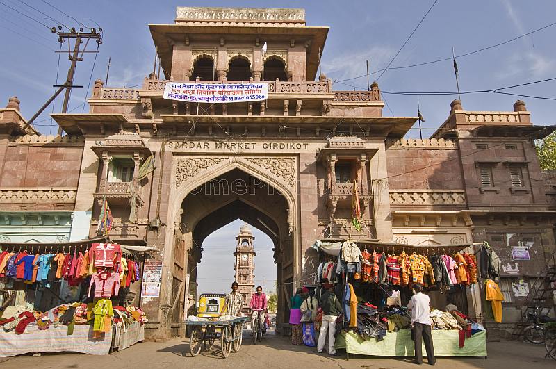 A vendor and his barrow passes through the gateway to Sardar Market.
