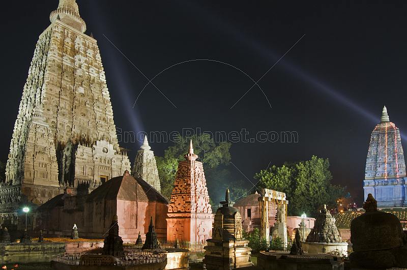 Twilight view of small stupas and shrines in front of the main Mahabodhi Temple.