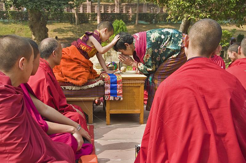 A young Bodhisattva blesses visiting Bhutanese pilgrims at the Mahabodhi Temple.