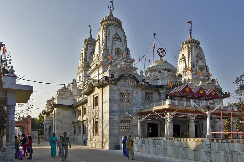Pilgrims walk outside the white marble Gorakhnath Temple.
