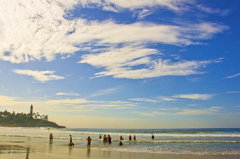 Indian tourists take an early morning dip in the sea at Lighthouse Beach.