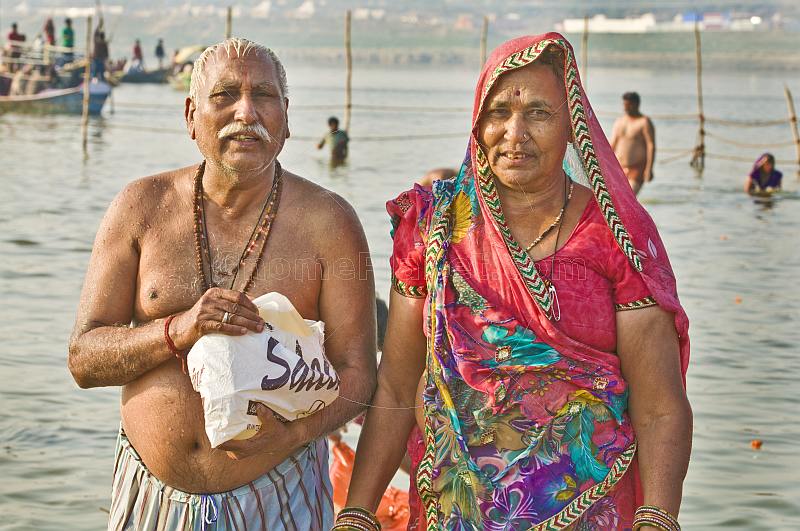 Elderly Indian couple pose after taking their sacred dip in Ganges river.