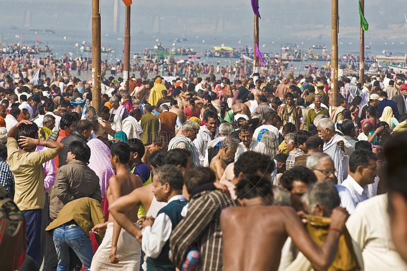 Huge crowds struggle to find space to change after sacred dip in the Yamuna river.