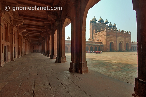 Walkway and courtyard of Akbar's Jami Masjid in early morning light.