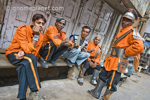 Indian bandsmen in orange uniforms.