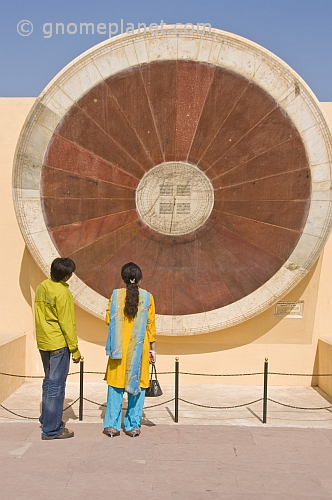 An Indian couple examine the Narivalaya Dakshin Gola, one of the astronomical instruments at the Jantar Mantar Observatory.