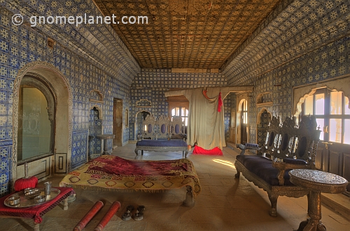 Maharajas bed chamber and huge night-gown in the seven-storey Juna Mahal.