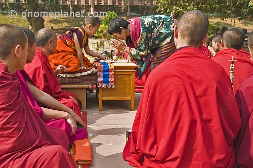 A young Bodhisattva blesses visiting Bhutanese pilgrims at the Mahabodhi Temple.