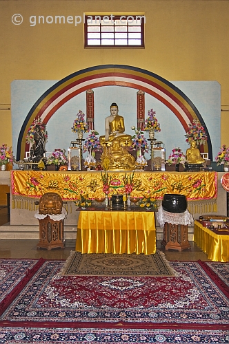 Gold-robed Buddha statue on the altar of the Chinese Buddhist Monastery at Sarnath.