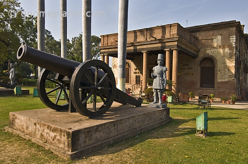 A siege cannon with statue of a period-costumer gunner stand outside the Residency building, now a museum to the Indian Mutiny of 1857.
