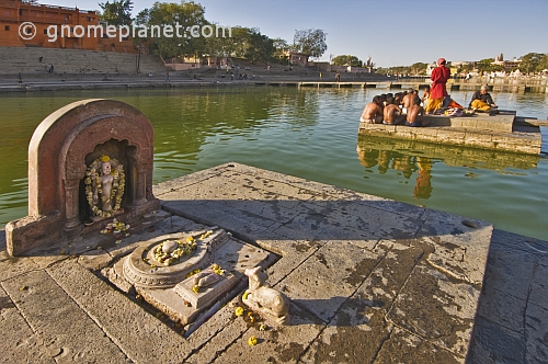 Hindu priests hold a ceremony on a puja platform in the Shipra River, the site of the 12-yearly Kumbh Mela.