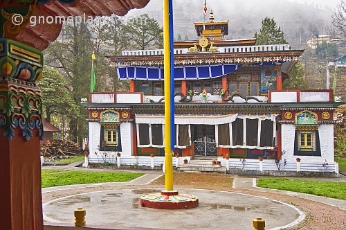 Flagpole and frontage of a Buddhist monastery.