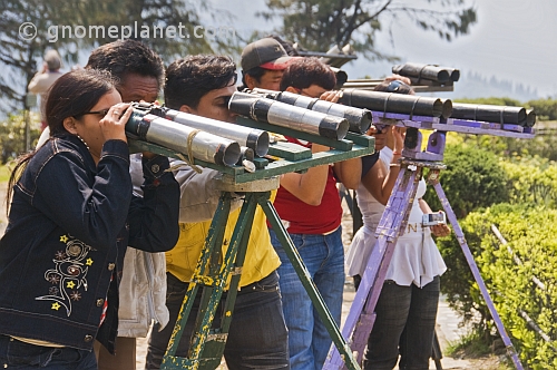 Indian tourists view the mountains through home made binoculars at the Batasia Loop.