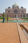 Indian father with young daughter takes a photograph of Humayun's Tomb.