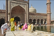 Muslim women perform ablutions before going to pray at Shah Jahan's Jama Masjid mosque.