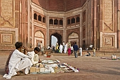 Religious trinket-sellers wait for pilgrims at the entrance to the Jami Masjid built 1571.