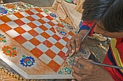 Young craftsman creating a chess board from inlaid-marble, or Pietra-Dura.