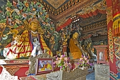 Buddhist statues in colorful robes at the Bhutanese Temple.
