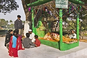 Muslim family pray before a shrine in the grounds of the Residency, scene of the 1857 Mutiny.