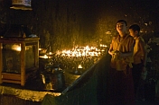 Two young trainee Buddhist monks prepare the oil lamps for the Enchey Monastery.