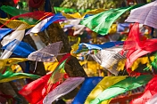Colorful Buddhist prayer flags dance in the wind at the Mahakala Temple on Observatory Hill.
