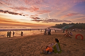 Indian bathers on Hawaa Beach watch the last rays of sunset.