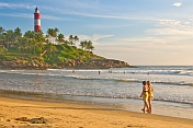 Two young Western women tourists walk along Lighthouse Beach.