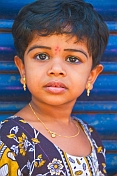 Small Indian girl in gold necklace and earings.