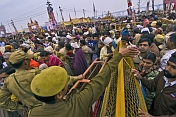 Indian police control the dense crowds at Basant Panchami Snana procession.