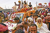 Mass crowds of Hindu Holy Men and jeeps block the Kumbh Mela procession road.