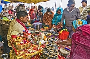 Hindu Holy Man provides religious requirements for Pilgrims at Kumbh Mela festival.