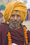 Smiling Hindu Holy Man With Orange Turban And Marigold Flower Garlands