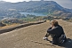 A tourist takes a photograph of Nakki Lake and Mount Abu town.
