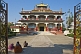 Image of Beggar women wait in front of the Tibetan temple and monastery.