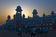 Image of Commuters hurry to catch their trains as dawn rises behind the main railway station.