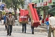 Image of Porters carry a three-piece suite of furniture along the pedestrianised M.G. Marg.