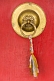Image of Brass door handle on a red monastery door.